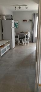 a kitchen and dining room with a table and a refrigerator at Elizabeth's apartment2 in Ofrínion +14 photos