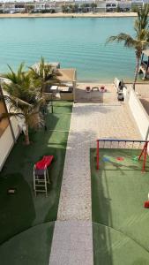 an aerial view of a beach with a playground at فيلا السعادة بيتش درة العروس رملي وخاص in Durat  Alarous +38 photos