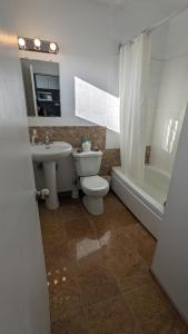 a bathroom with a toilet and a sink and a tub at Deerview Lodge & Cabins - Princeton BC in Princeton +26 photos