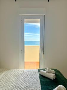 a bedroom with a bed with towels on it at Apartamento Benalbeach in Benalmádena