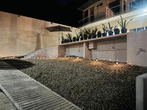 a building with potted plants on the side of it at Casa Tachu in Puerto Escondido