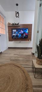 a living room with a flat screen tv on a wall at Boho Chic Relaxing Space in Fajardo