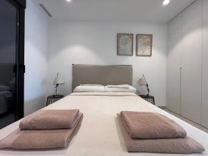 a bedroom with a large bed with two pillows on it at Casa Verde in Molino de las Ánimas +44 photos