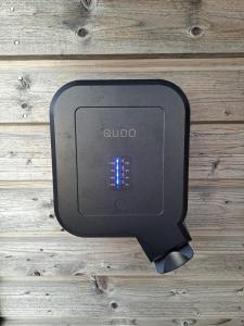 a black tv on a wooden wall at Austurey - Lakefront Villa in Laugarvatn