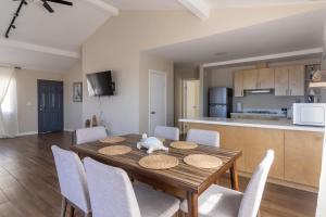 a dining room table with chairs and a kitchen at New Casa Marea #2 Beach Front House 2BR Wifi AC in Colonia Cuauhtemoc