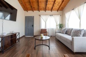 a living room with a couch and a table at NEW Casa Marea Beach Front House DT 2BR WiFi & AC in Colonia Cuauhtemoc