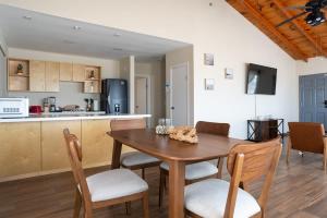 a kitchen and dining room with a wooden table and chairs at NEW Casa Marea Beach Front House DT 2BR WiFi & AC in Colonia Cuauhtemoc