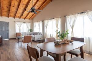 a living room with a table and chairs and a couch at NEW Casa Marea Beach Front House DT 2BR WiFi & AC in Colonia Cuauhtemoc +20 photos