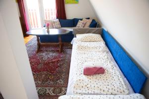 a room with a bed and a table and a couch at Planinska kuća S&I in Dejčići