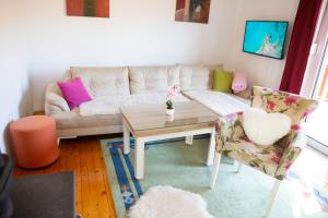 a living room with a couch and a table and chairs at Planinska kuća S&I in Dejčići