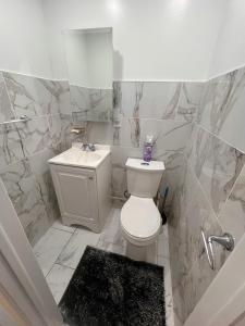 a white bathroom with a toilet and a sink at Amazing private single family house in Glendale +31 photos