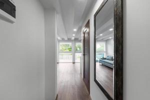 a hallway with a mirror and a couch in a room at Studija-butas Markučiuose in Vilnius