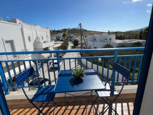 a blue table and chairs on a balcony at Cozy Corner Marmara Paros in Dhragoulás