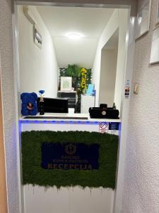 a entrance to a reception desk with a sign on it at Baroko Rooms & Apartments in Varaždin