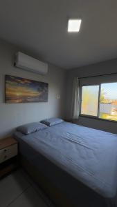 Una cama o camas en una habitación de Residencial Nova Taíba CE com vista para o mar