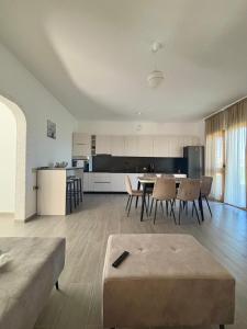 a living room and kitchen with a table and chairs at Albert's house for rent in Vlorë