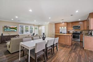 a kitchen and living room with a table and a couch at Entertaining 5 Bedrooms Luxury DC Vibe in Springfield