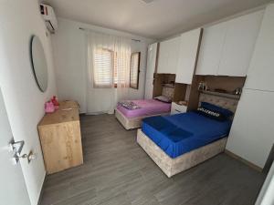 a bedroom with two beds and a couch in it at Albert's house for rent in Vlorë