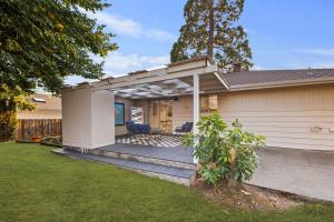 a pergola on a house with a yard at Shorewood Retreat -10 mins to Seattle-private yard in Burien