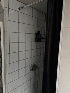 a bathroom with a shower with a black shower curtain at Dein Zuhause auf Zeit! in Güster