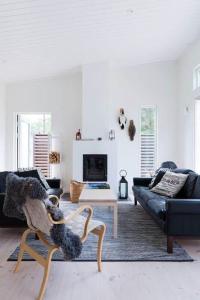 a living room with a couch and a table at OGO730-Vikbolandet-Vaerldens-Aende-46 in Arkösund