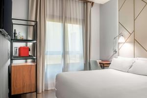 a hotel room with a bed and a window at NH Collection León Plaza Mayor in León