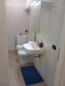 Un baño con lavabo, inodoro y espejo. en Miramare4, en Ceriale