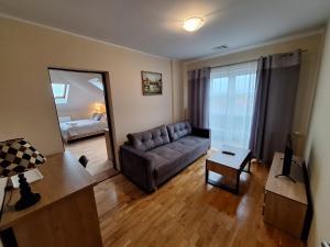 a living room with a couch and a table at Aparthotel Xavito in Sanok