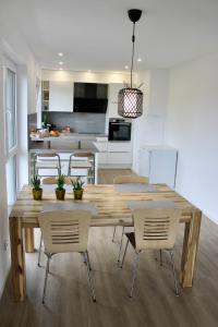 Una cocina y un comedor con mesa y sillas de madera. en Modernes deluxe Apartment für 4 Pers in Kaarst Nähe Düsseldorf, en Kaarst 13 fotos más