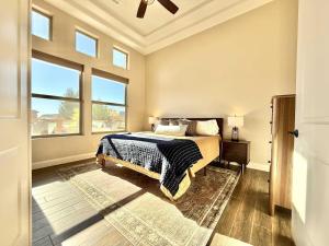 een slaapkamer met een bed en twee ramen bij Upscale 4 bedroom family home near Zion w pool & hot tub in Kanab +36 foto's