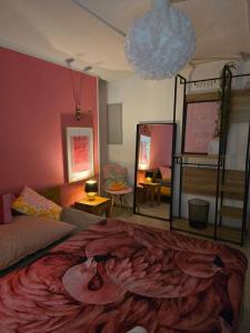 a bedroom with a large bed with a painting on it at Hostel Bertha-Marie Flamingo Lounge in Greifswald