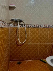 a shower in a bathroom with a toilet at Laverie du Soleil Surf House in Taghazout