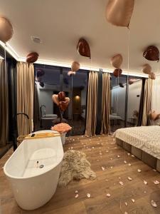 a bedroom with a bath tub and a bed at Nest House in Dubova