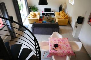 a living room with a couch and chairs and a table at Escapade Champêtre in Chevaigné