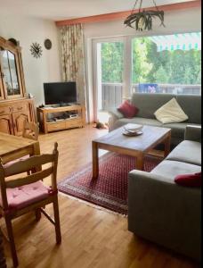 a living room with a couch and a table at Ferienwohnung In Frauenberg Mit Garten in Haidmühle