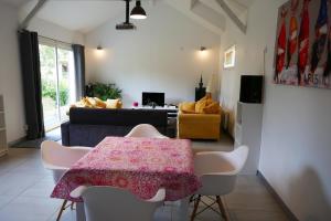 a living room with a table and a couch at Escapade Champêtre in Chevaigné