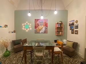 a living room with a glass table and chairs at Casa VicoloLungo Nardó in Nardò