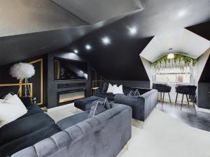 a living room with a couch and a tv at Queen Elizabeth Penthouse Sleeps 6-8 in Stanhope