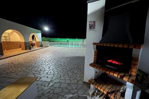a fireplace in the middle of a patio at night at Villa Calatrue - Tabernas in Tabernas