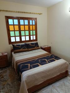 Ένα ή περισσότερα κρεβάτια σε δωμάτιο στο Maison de vaccances Raouia