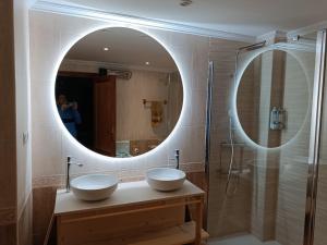 a bathroom with two sinks and a large mirror at Casa Caldereta in Ayelo de Rugat