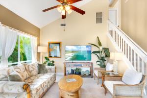 a living room with a couch and a tv at Regency 620 in Koloa
