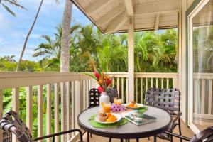 a table on a porch with food on it at Regency 620 in Koloa