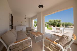 a living room with a couch and a table at Terra Mater - Exclusive Cottage - in Ostuni