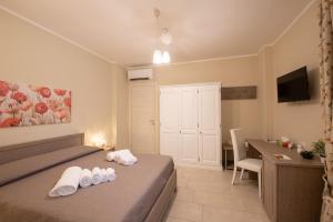 a bedroom with a bed and a desk with a computer at Terra Mater - Exclusive Cottage - in Ostuni