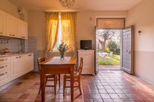 a kitchen with a table and chairs and a television at Marica in Pesaro