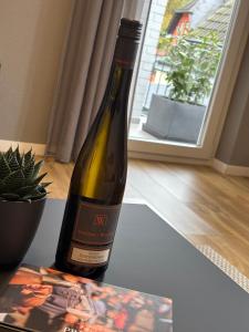 a bottle of wine sitting on a table with a cactus at Ferienwohnung am Engelmannsberg in Hattenheim