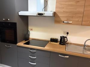 a kitchen with a sink and a counter top at Tedds Cosy 2 bedroom Apartment in Tal-Pietà +3 photos