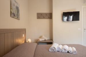 a bedroom with a bed with towels on it at Terra Mater - Exclusive Cottage - in Ostuni +49 photos