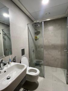 a bathroom with a toilet and a sink and a shower at Cozy Room In Abu Dhabi Reem island Near to Galeria Mall in Abu Dhabi +10 photos